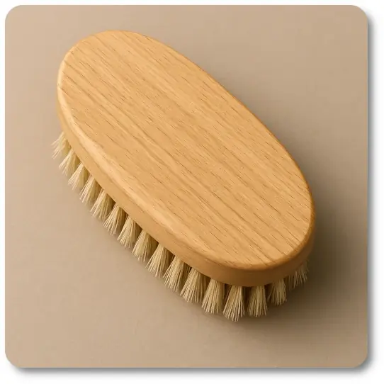Military-style oval hairbrush with natural boar bristles and a polished wooden body, shown against a neutral taupe background