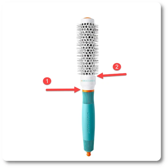 Moroccanoil ceramic round brush with turquoise handle and ceramic barrel, shown vertically against a neutral salon-style background. Two red arrows labeled 1 and 2 highlight known snag points where long hair can catch during styling